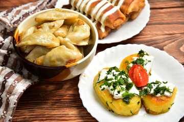 Ukrainian cuisine dumplings with filling, pancakes with meat and sour cream, potato tortillas with minced meat
