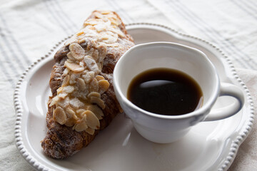 Almond Croissant with a cup of hot coffee for Breakfast 