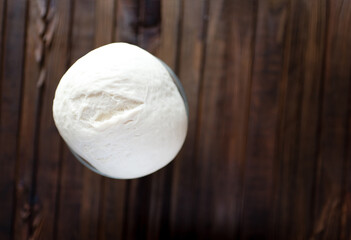 Process of raising the dough in a special basket. Dough made from natural sourdough. Wheat dough. Fermentation. Top view.	