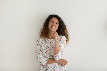 Happy pretty Hispanic young 30s woman in casual looking at camera with toothy smile, laughing,...