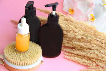 spa treatments. Massage oil massage brush for cellulite. Bottles of oil and lotion. Jars of shampoo and balm. Jars for brown cosmetics with a dispenser.