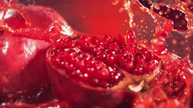 Slow Motion Shot of Pomegranate Juice Splashing through Pomegranate