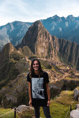 Naklejka premium Young female tourist with Llama t shirt at Machu Picchu in Peru