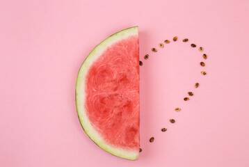 Watermelon slice with heart made from seeds. Love summer concept. Space for text. Love fruits