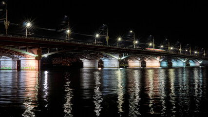 Fototapeta na wymiar Chernavsky bridge over the Voronezh reservoir in the autumn night