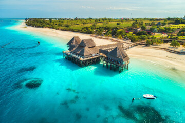 Aerial view of beautiful hotel in Indian ocean at sunset - obrazy, fototapety, plakaty