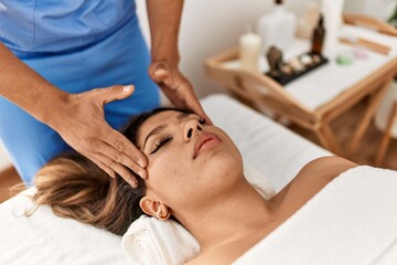 Fototapeta na wymiar Woman reciving head massage at beauty center.