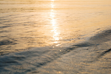 blur sunlight plays on the river ripple surface. sunset water surface. water background. blue and sunny water surface. abstract blue water