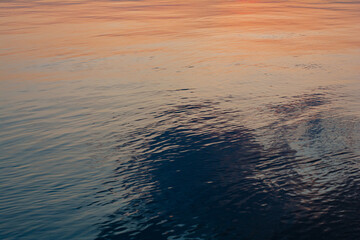 blue and yellow river surface. water surface. water background. blue and orange water surface. abstract blue water
