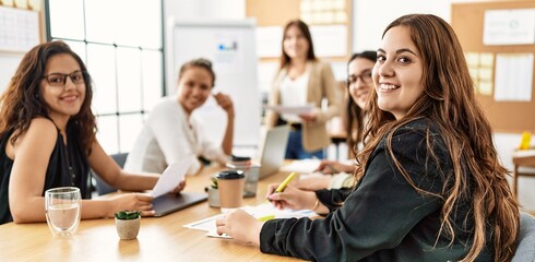 Group of young businesswomen listening boss conference during meeting at the office.