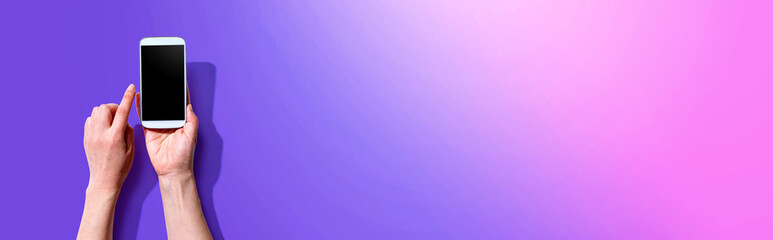 Person using a white smartphone from above