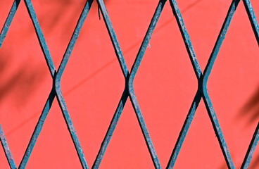 Blue mesh detail, rhombus grid on red background