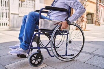 Middle age hispanic man wearing business clothes sitting on wheelchair at street