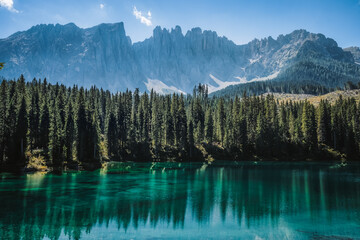 wonderful mountain scenery of the turquoise water of the moraine Carezza Lake lake and silhouette...