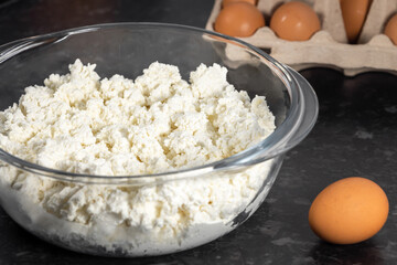 Preparing dough for curd fritters, curd and eggs, selective focus