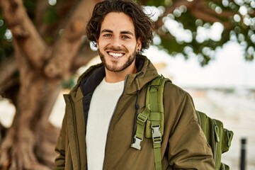 Obraz premium Handsome hispanic man smiling at the park