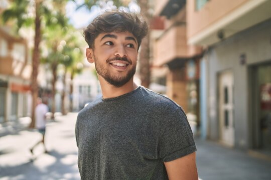 Young arab man smiling happy standing at the city.