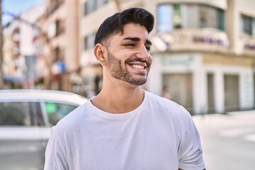 Fototapeta premium Handsome hispanic man smiling happy outdoors