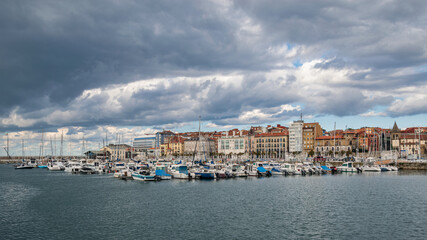 Fototapeta na wymiar Gijon city marina with dramatic clouds, Asturias Spain.