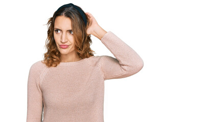 Fototapeta premium Beautiful young caucasian woman wearing casual sweater confuse and wondering about question. uncertain with doubt, thinking with hand on head. pensive concept.