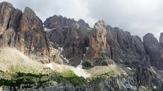 4K aerial flying up drone footage of a picturesque Dolomite Alps ridges and peaks. Drone point of view flying up at cca 2200m near Gardena Pass, South Tyrol, northeastern Italy.