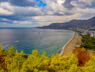 Fototapeta na wymiar sunny view of Alanya and the port against the backdrop of mountains and clouds in autumn