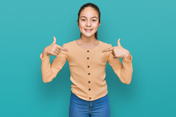Beautiful brunette little girl wearing casual sweater looking confident with smile on face,...