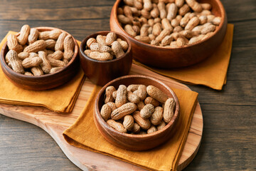 Image of bunch of peanuts in a bowl on a wooden table