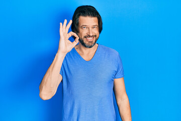 Middle age caucasian man wearing casual clothes smiling positive doing ok sign with hand and fingers. successful expression.