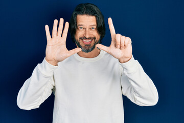 Naklejka premium Middle age caucasian man wearing casual clothes showing and pointing up with fingers number seven while smiling confident and happy.
