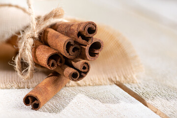 Cinnamon sticks on a white wooden board