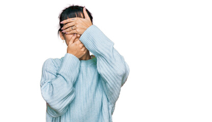 Young hispanic woman wearing casual clothes covering eyes and mouth with hands, surprised and shocked. hiding emotion