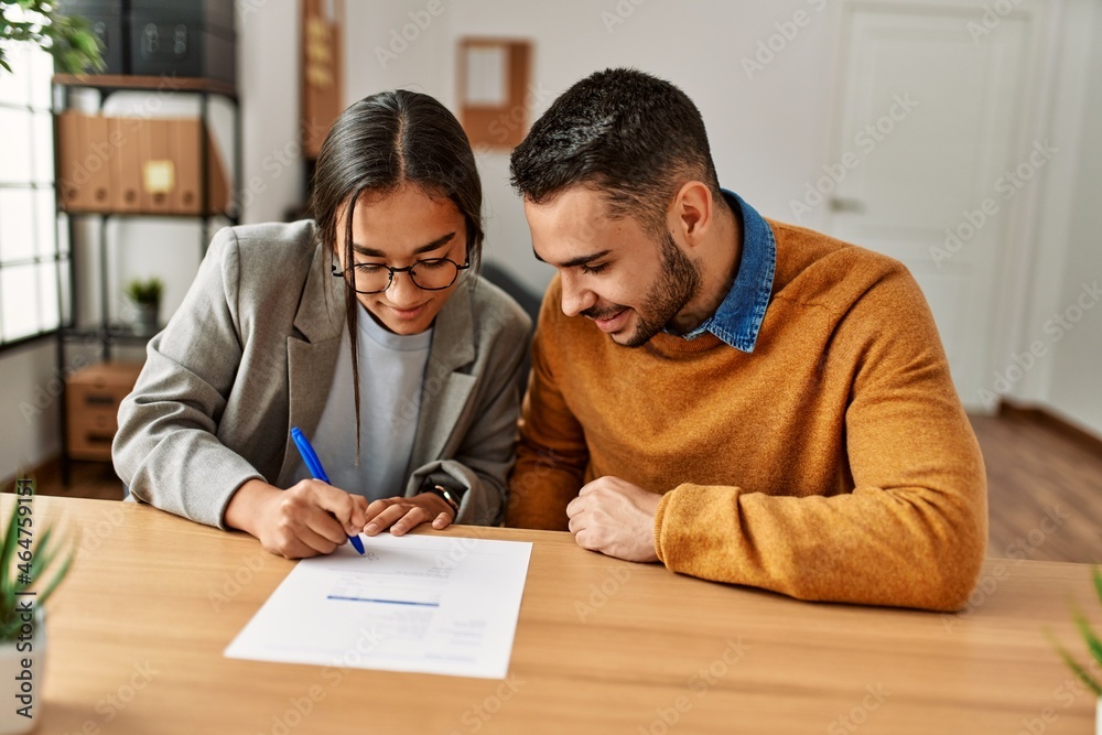 Canvas Prints Couple smiling happy reading document at the office.