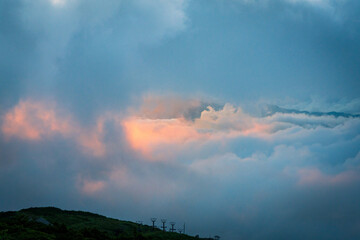 Dynamic clouds glowing in the morning sun.