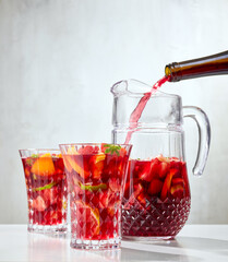 red wine pouring into jug