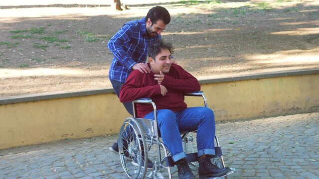 living with a disability - slow motion on  woman intervening to defend a disabled young man from an overly intrusive friend