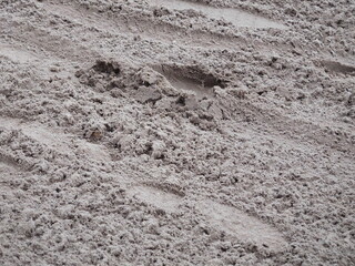 abstract textured background footprints in the sand close up ,tracks in sand