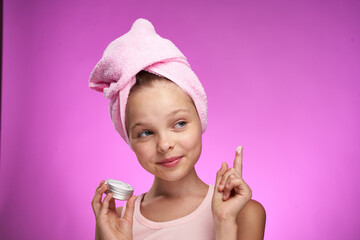 girl with a towel on her head cosmetics decoration close-up purple background