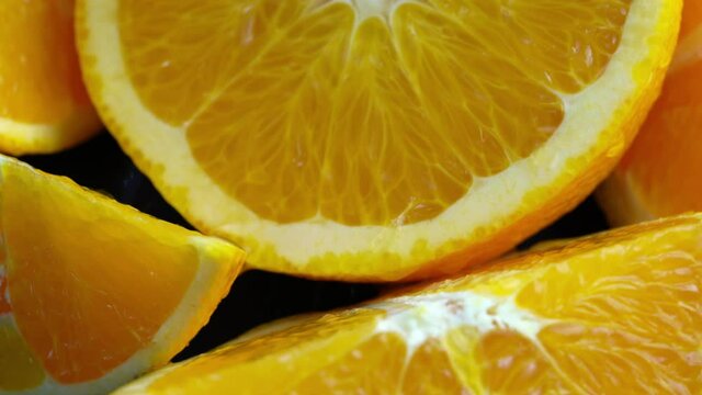 Top view orange juice splash on orange slice, Fresh Orange squeezing with fresh orange juice in black plate, 4k resolution.