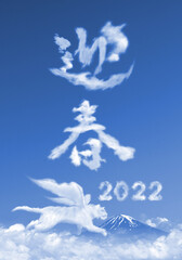 雲で描いた「2022」と「迎春」の文字。雲の上を翔ぶ「寅」背景には凛々しい富士山。