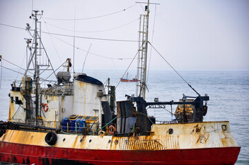 Stern of a fishing vessel with a fishing boat in the background