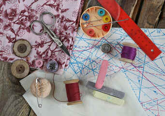 Set of tools for sewing clothes and acessoires on the table,top view.