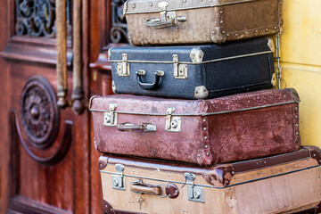 Vintage classic outdated trunks luggage with tags, old antique leather suitcases. Travel baggage concept. Retro style filtered photo