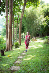 Young lady relaxing in the natural park. Vacation on Summer in the garden. Feeling and freedom.Lifestyle Concept.