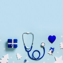 Merry Christmas and Happy New Year medicine concept, soft toy heart, stethoscope, gift present box, background with copy space