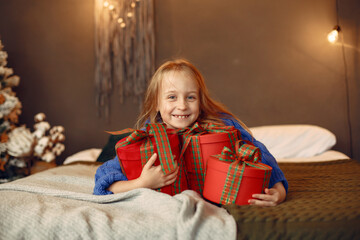 Fototapeta na wymiar Little girl spends time in the holiday room