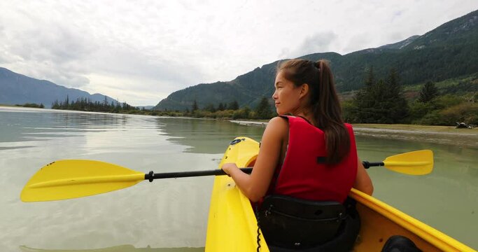 Kayak. Woman kayaking in Squamish paddling in Squamish Estuary surrounded by mountains relaxing enjoying tranquility. People living healthy active outdoor lifestyle in British Columbia, Canada