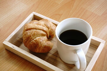  breakfast Croissant and black coffee,