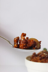 fried chicken with soy sauce on spoon