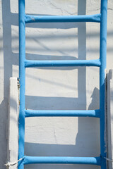 blue ladder in white wall